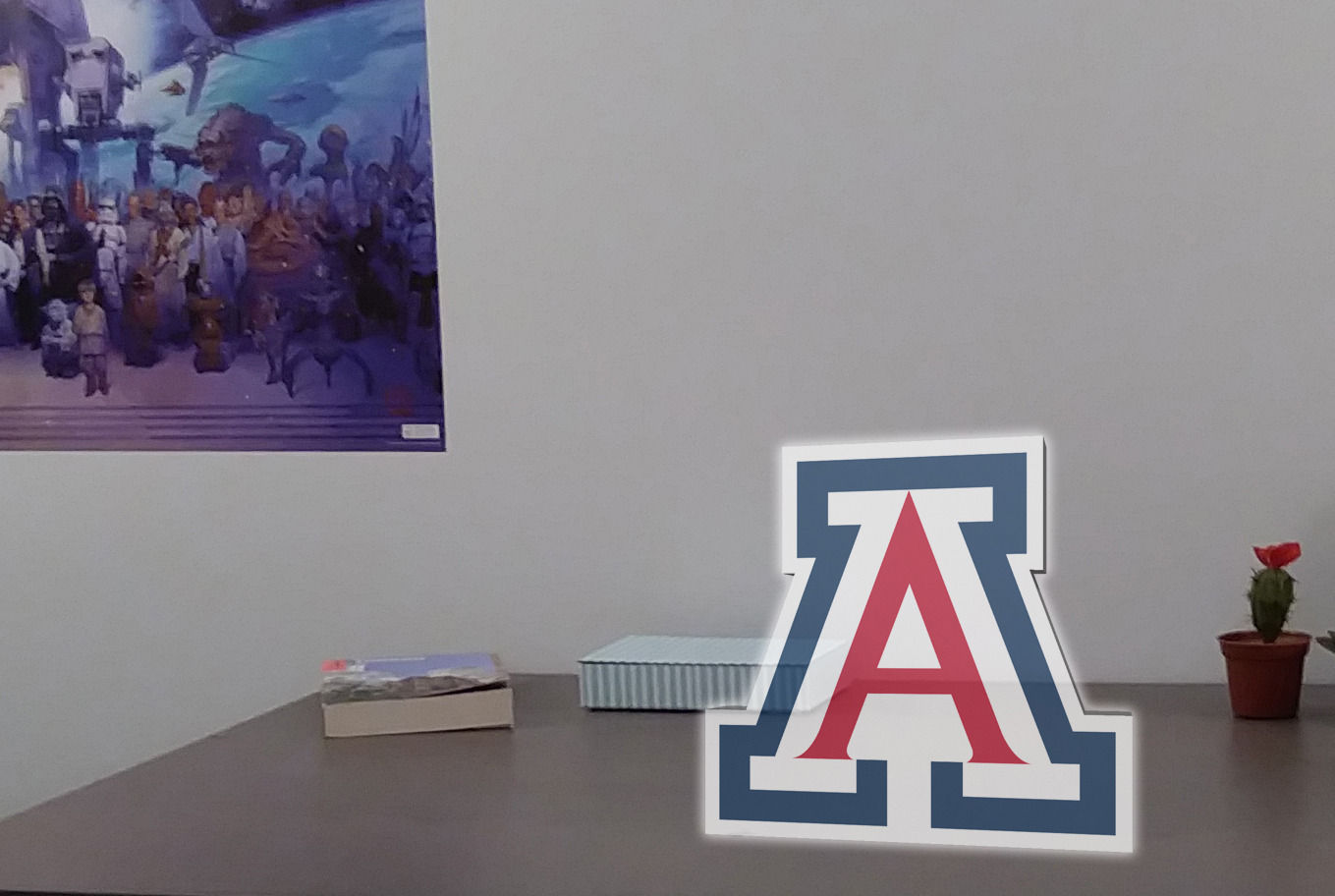 Image showing room with augmented reality "A" logo appearing on desk